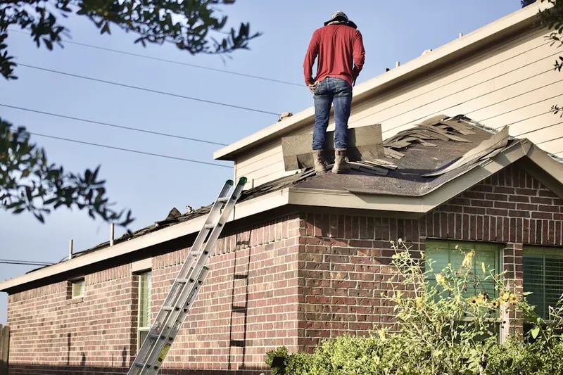 Professional roofer working on a residential roof in Tarpey